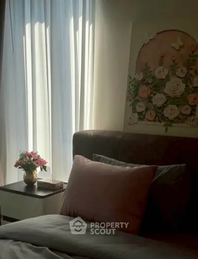 Cozy bedroom with soft lighting, elegant floral decor, and plush bedding for a serene retreat.