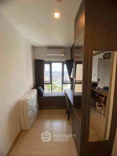 Cozy study room with city view, featuring a built-in desk and ample natural light.