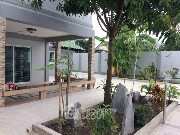 Charming modern home with lush garden and spacious patio area.