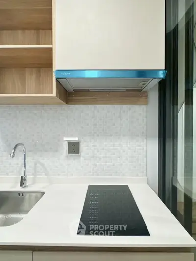 Modern kitchen with sleek induction cooktop and stylish cabinetry