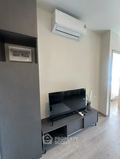 Modern living room with sleek TV unit and air conditioning