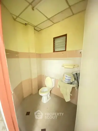 Cozy bathroom with pastel tiles and essential fixtures, perfect for a compact living space.