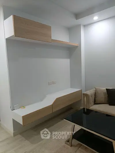 Modern living room with sleek wooden shelves and stylish black coffee table