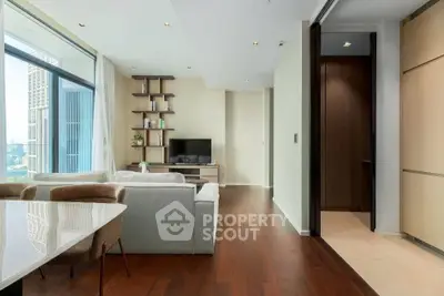 Modern living room with sleek design and city view, featuring hardwood floors and contemporary furniture.