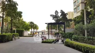 Luxurious residential complex with lush gardens and modern architecture.