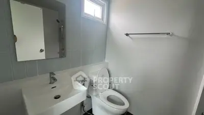 Modern bathroom with sleek fixtures and natural light.