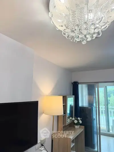 Modern living room with elegant chandelier and balcony view