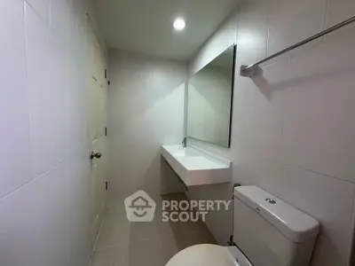 Modern minimalist bathroom with sleek fixtures and neutral tiles