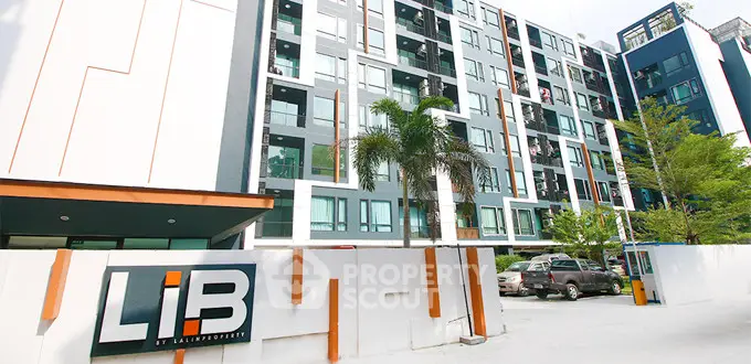 Modern apartment building exterior with contemporary design and lush greenery.