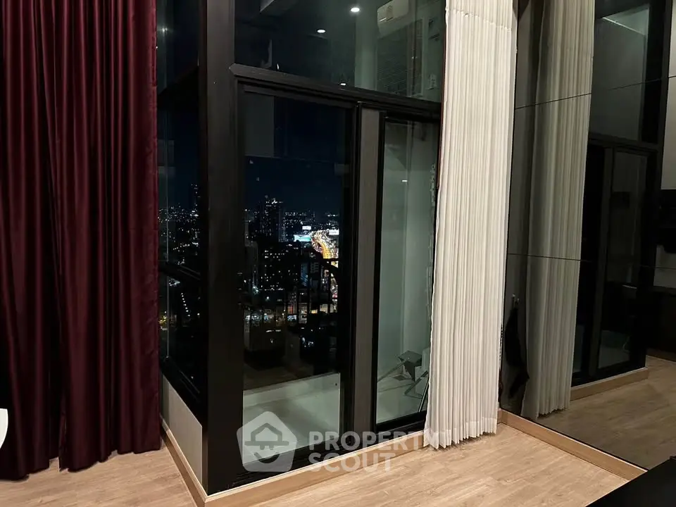Luxurious high-rise apartment with stunning city night view and floor-to-ceiling windows.