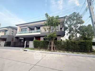 Modern two-story house with sleek design and spacious balcony in a serene neighborhood.