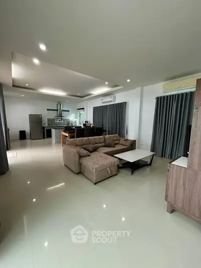 Spacious modern living room with open kitchen and stylish furnishings