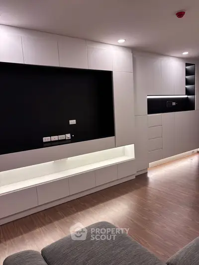 Modern living room with sleek built-in storage and elegant lighting