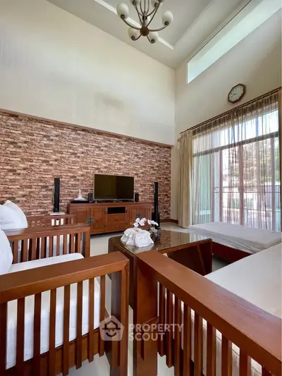 Spacious living room with high ceiling and elegant wooden furniture
