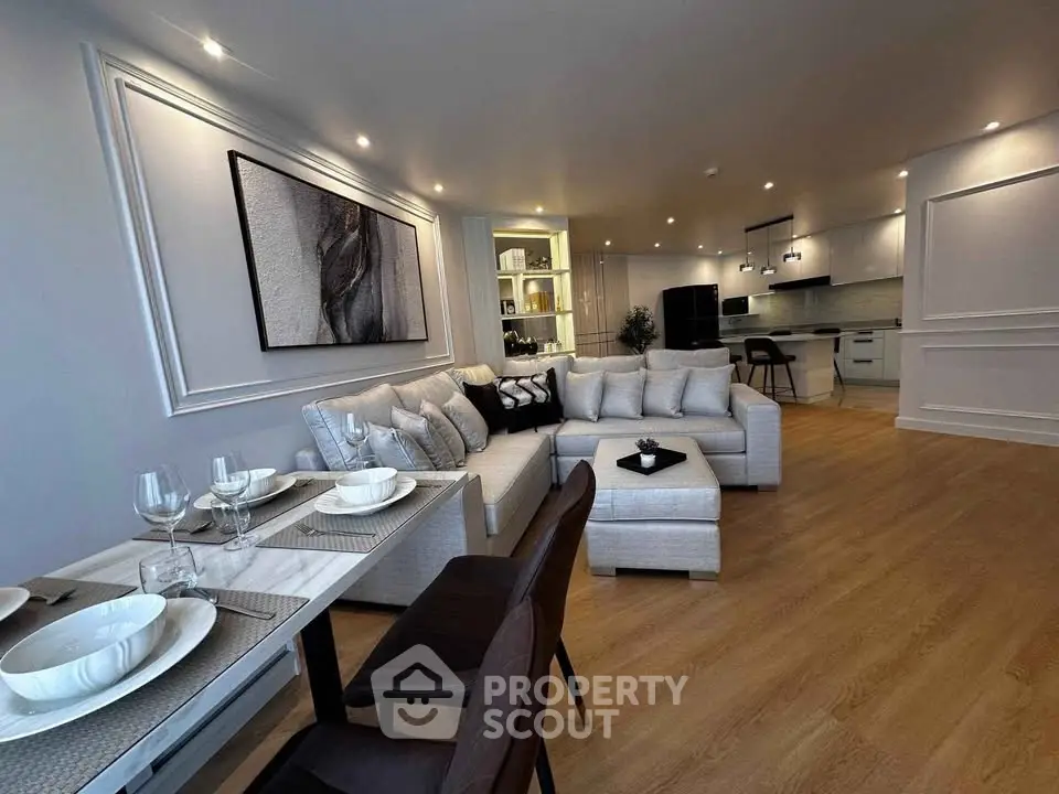 Luxurious open-plan living room with elegant decor and modern kitchen