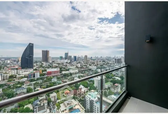 Stunning cityscape view from a high-rise balcony with modern railing.