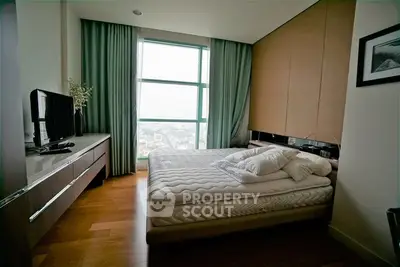 Modern bedroom with large window and stylish decor in urban apartment