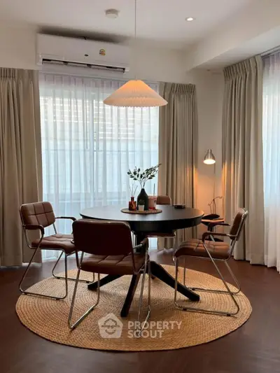 Chic dining area with modern round table and stylish chairs, perfect for intimate gatherings.