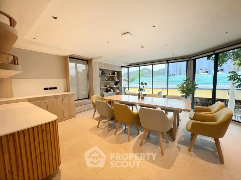 Spacious dining area with modern decor and large windows offering scenic views.
