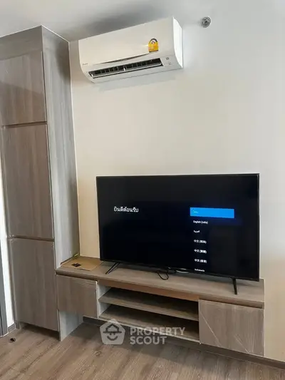 Modern living room with sleek TV unit and air conditioning, perfect for comfortable living.