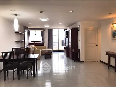 Spacious living room with modern furniture and large windows offering natural light.
