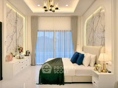 Luxurious bedroom with elegant decor and large windows offering natural light.