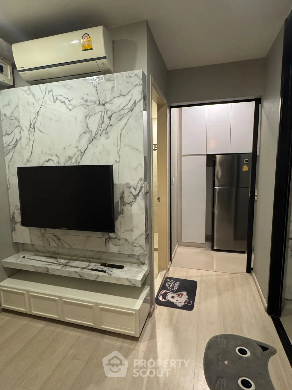 Modern living room with marble accent wall and sleek TV setup