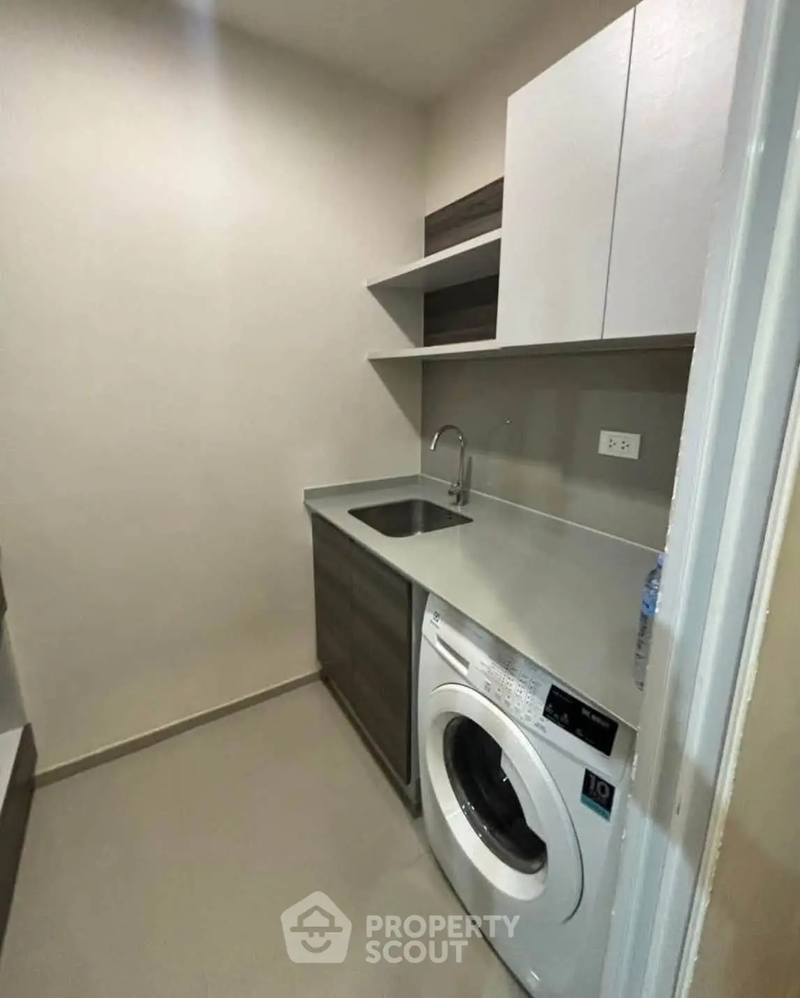 Modern laundry room with washing machine and sleek cabinetry