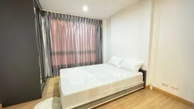 Modern minimalist bedroom with large window and stylish curtains