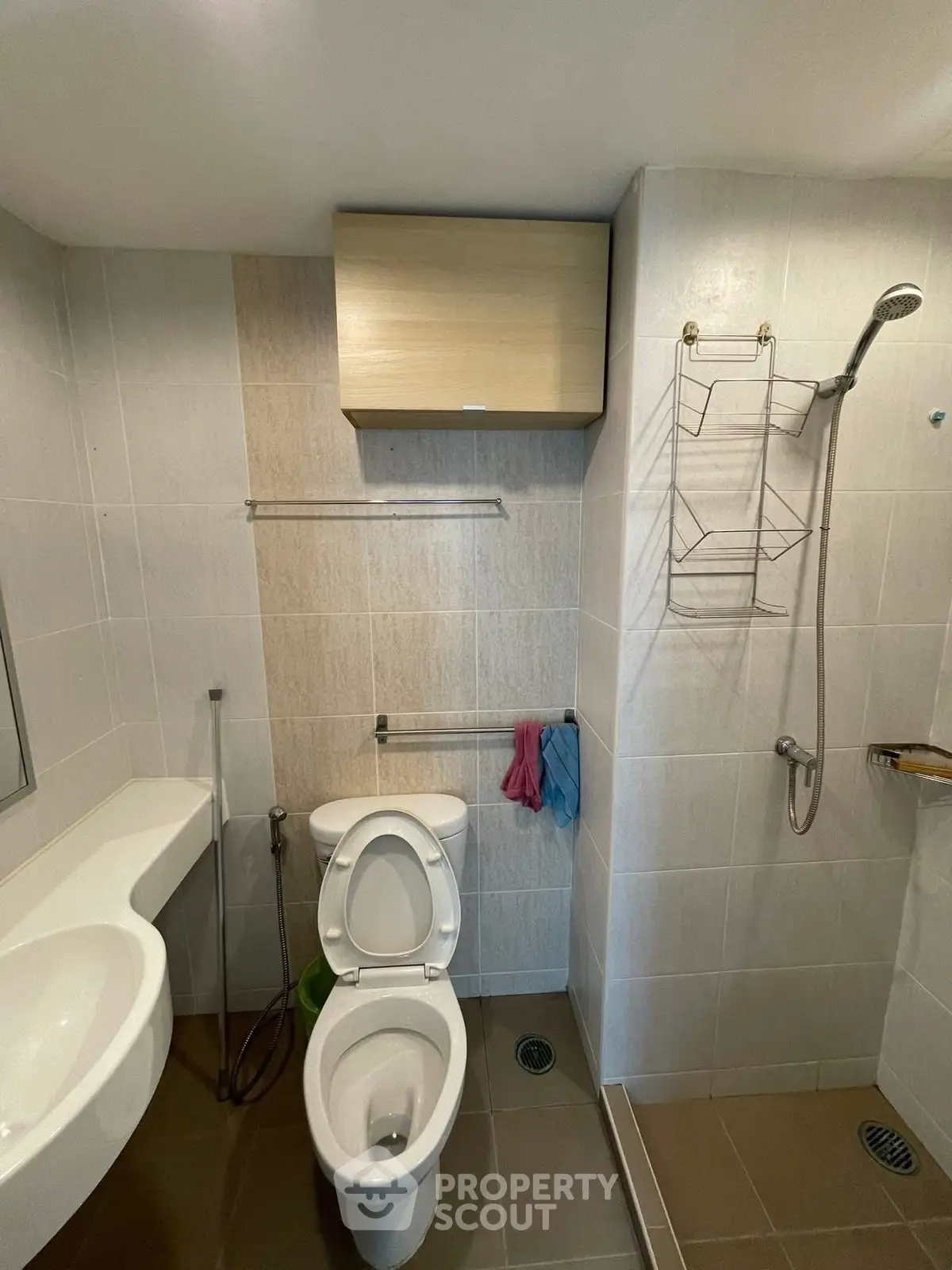 Modern bathroom with sleek fixtures and open shower design in a contemporary apartment.
