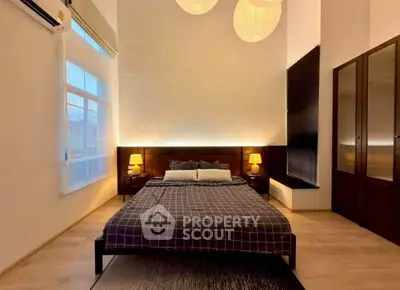 Spacious bedroom with modern decor and ambient lighting