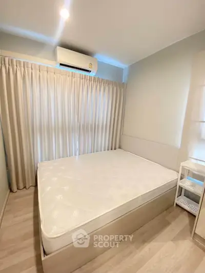 Cozy bedroom with natural light and modern air conditioning unit