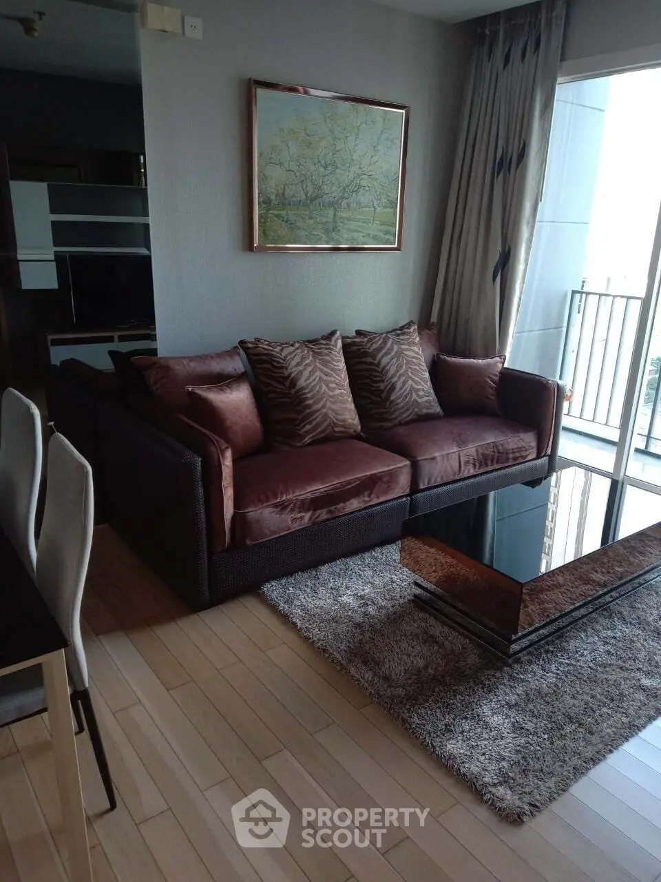 Stylish living room with plush sofa, elegant decor, and balcony access in modern apartment.