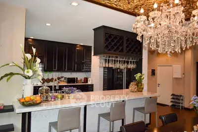 Luxurious kitchen with marble island and elegant chandelier
