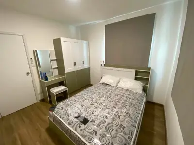 Modern bedroom with stylish furniture and cozy ambiance, featuring a comfortable bed and sleek wardrobe.