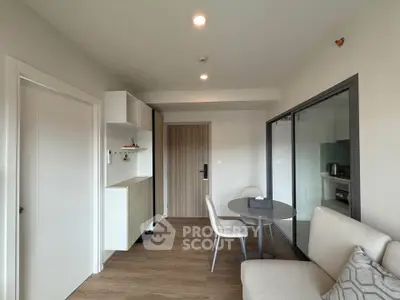 Modern living room with cozy seating and dining area in a stylish apartment.