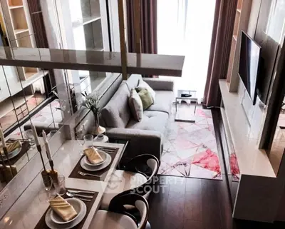 Modern living room with stylish decor and dining area in a cozy apartment.