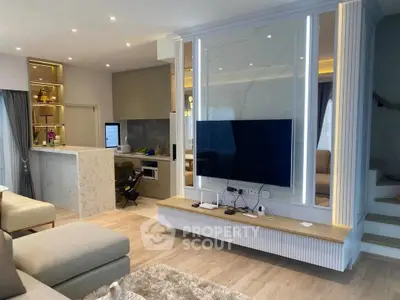 Modern living room with open kitchen, stylish decor, and cozy seating area in a contemporary home.