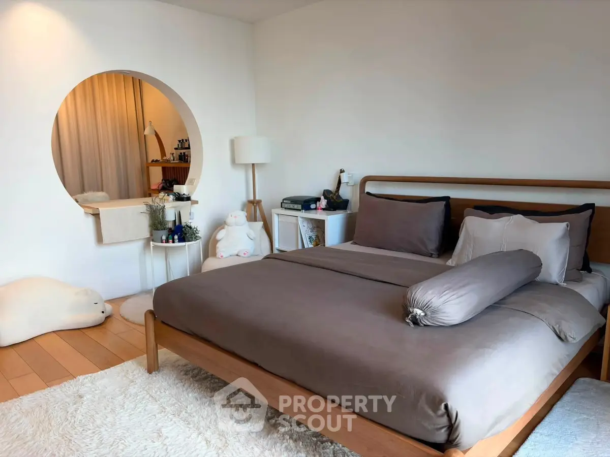 Stylish bedroom with modern decor and cozy ambiance, featuring a plush bed and elegant furnishings.