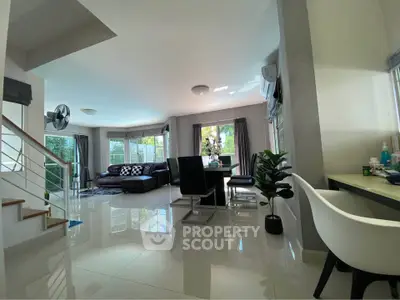 Spacious modern living room with elegant dining area and natural light