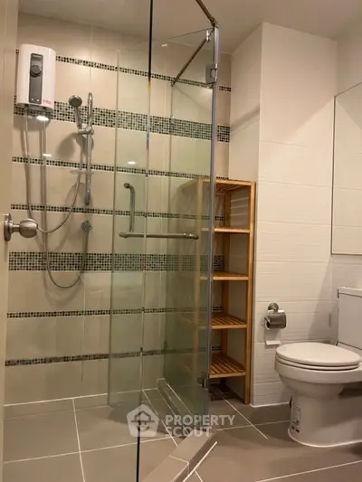 Modern bathroom with glass shower enclosure and sleek tile design