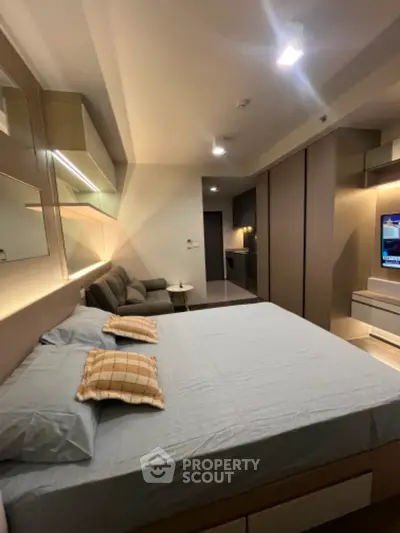 Modern bedroom with sleek design and cozy ambiance, featuring stylish furniture and ambient lighting.
