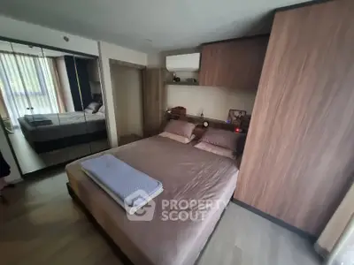 Cozy bedroom with modern wooden furniture and large mirrored wardrobe