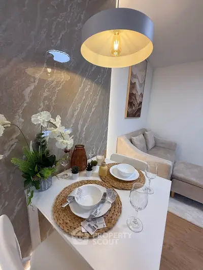 Stylish dining area with elegant table setting and cozy seating in modern apartment