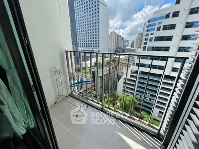 Modern city view from a high-rise balcony with sleek railing and urban skyline.