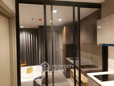 Modern studio apartment with sleek kitchen and cozy bedroom area