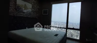 Modern bedroom with large window offering stunning city view, featuring stylish decor and comfortable bed.