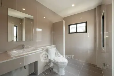 Modern bathroom with sleek fixtures and large windows for natural light.