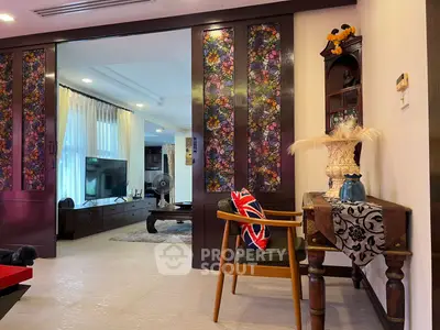 Charming living room with stylish decor and sliding stained glass doors