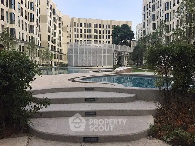 Modern residential complex with pool and landscaped surroundings